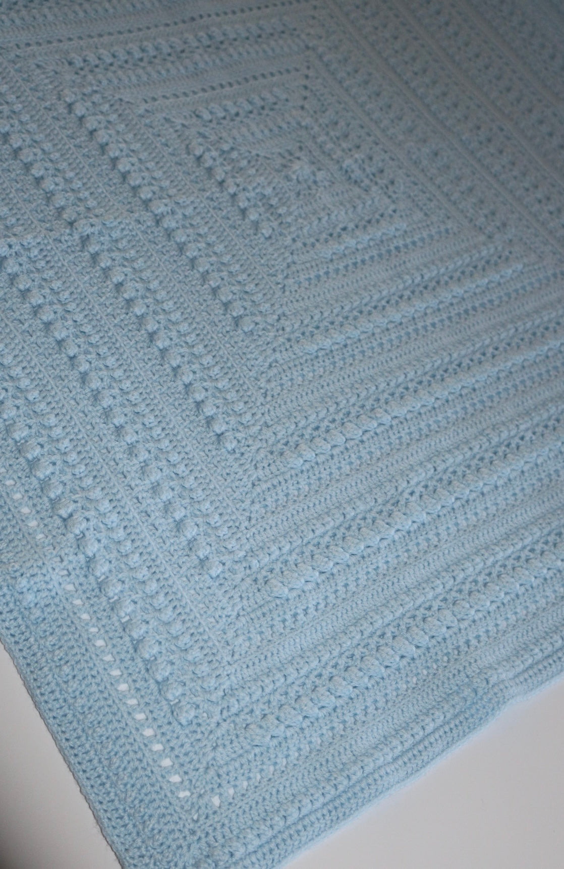 Angled view of blue baby blanket